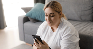 A woman uses her phone to connect with a smaller adoption agency for personalized support.